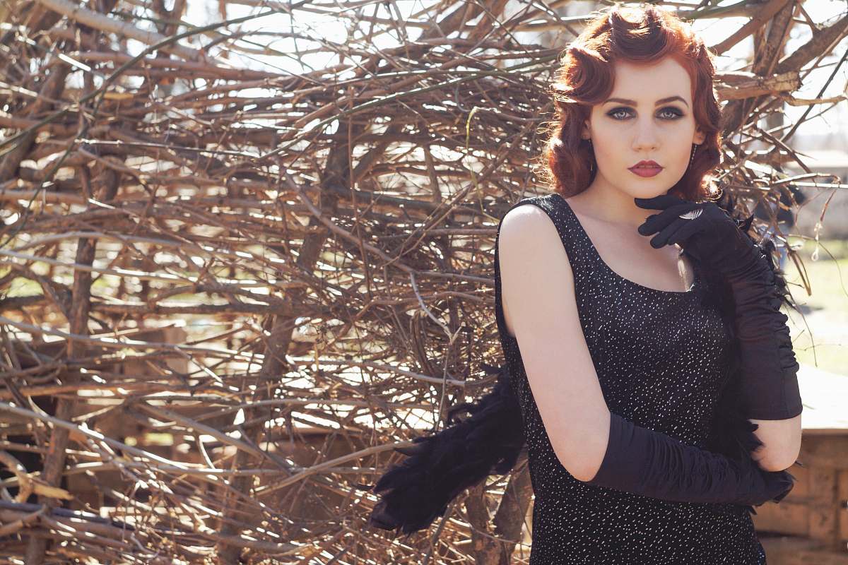 people woman wearing black sleeveless scoop-neck top and black gloves woman