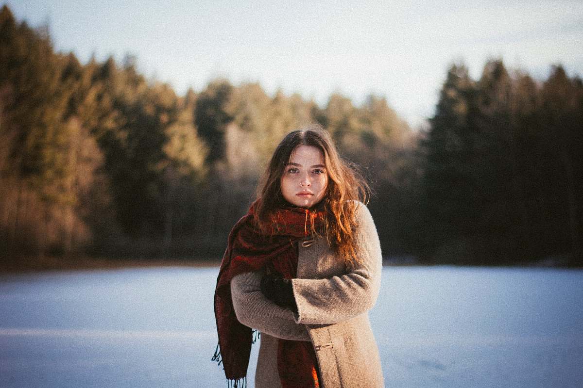 people woman wearing brown coat and red scarf human