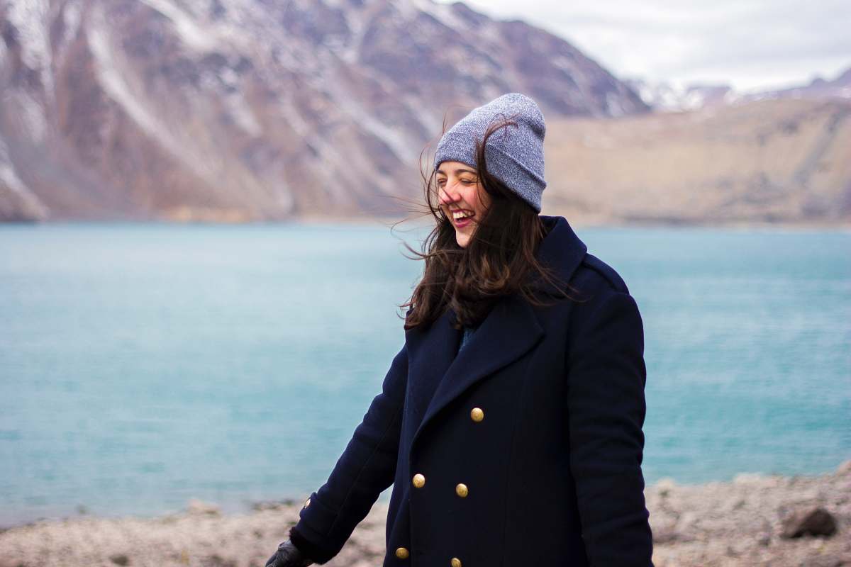 human woman wearing coat near shore people