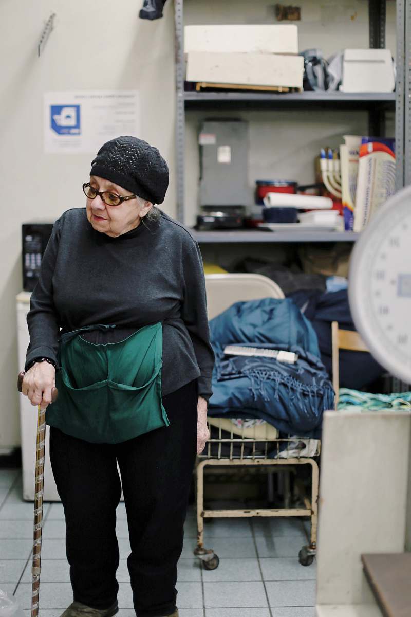 people woman wearing gray top and black pants walking using walking cane human