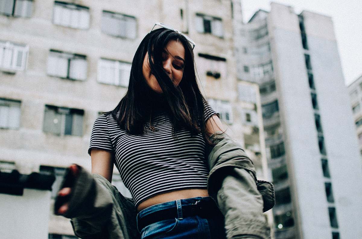 human woman wearing striped crop-top and jacket people