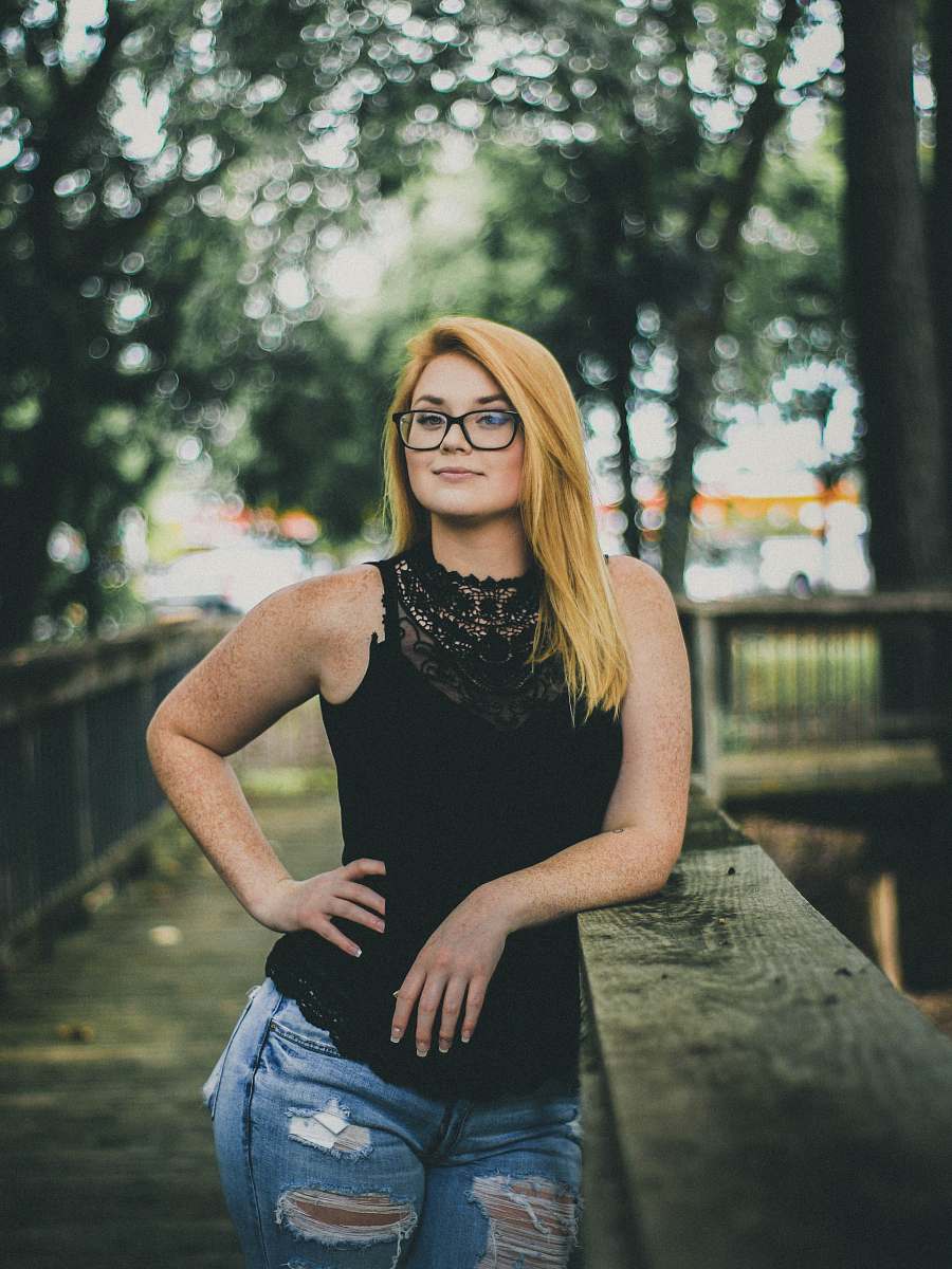 human woman's arm leaning on bridge holding her waist people