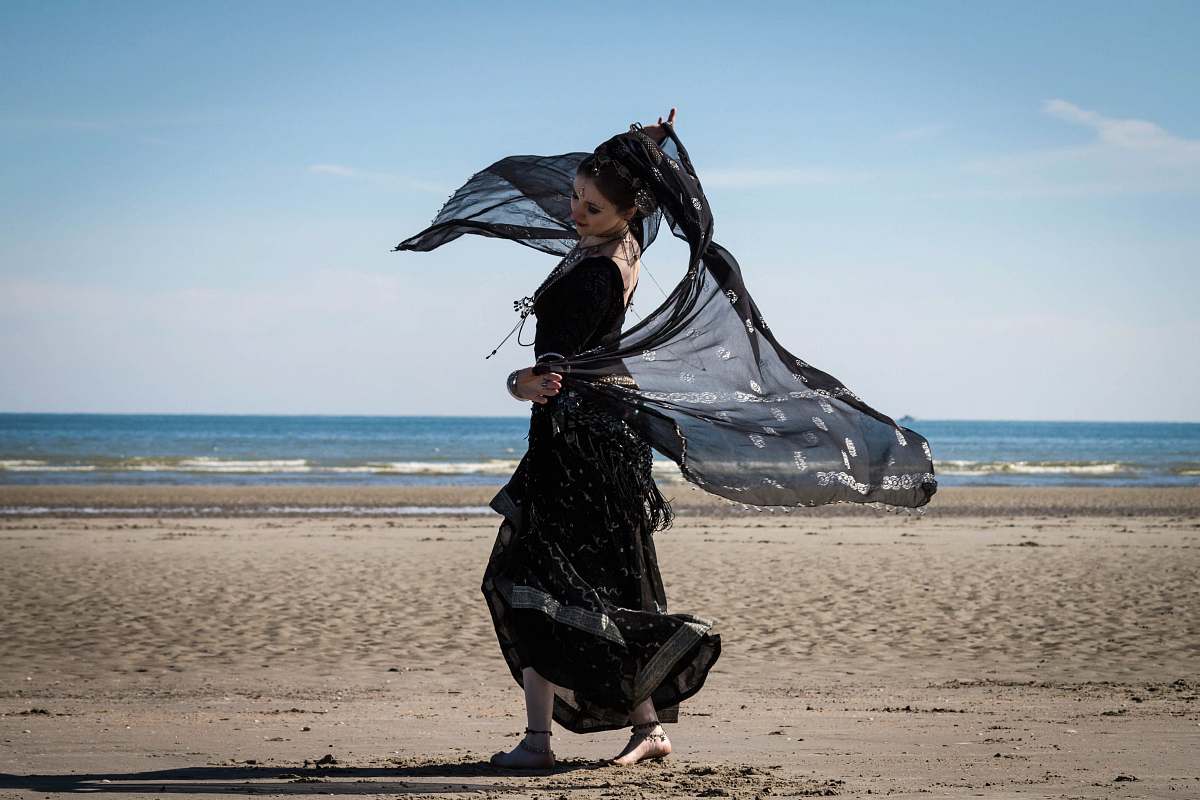 beach woman dancing on seashore water