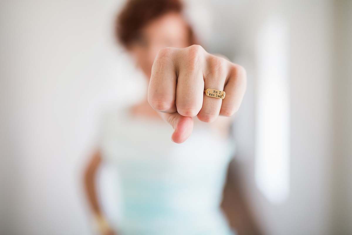 ring woman showing gold-colored ring fist