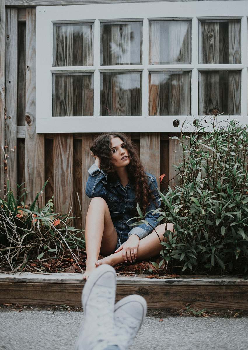 plant woman sitting under white wooden window people