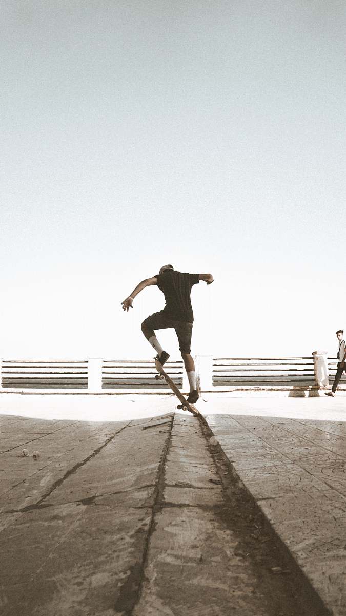 clothing close-up photography of person doing stunt on skateboard shorts