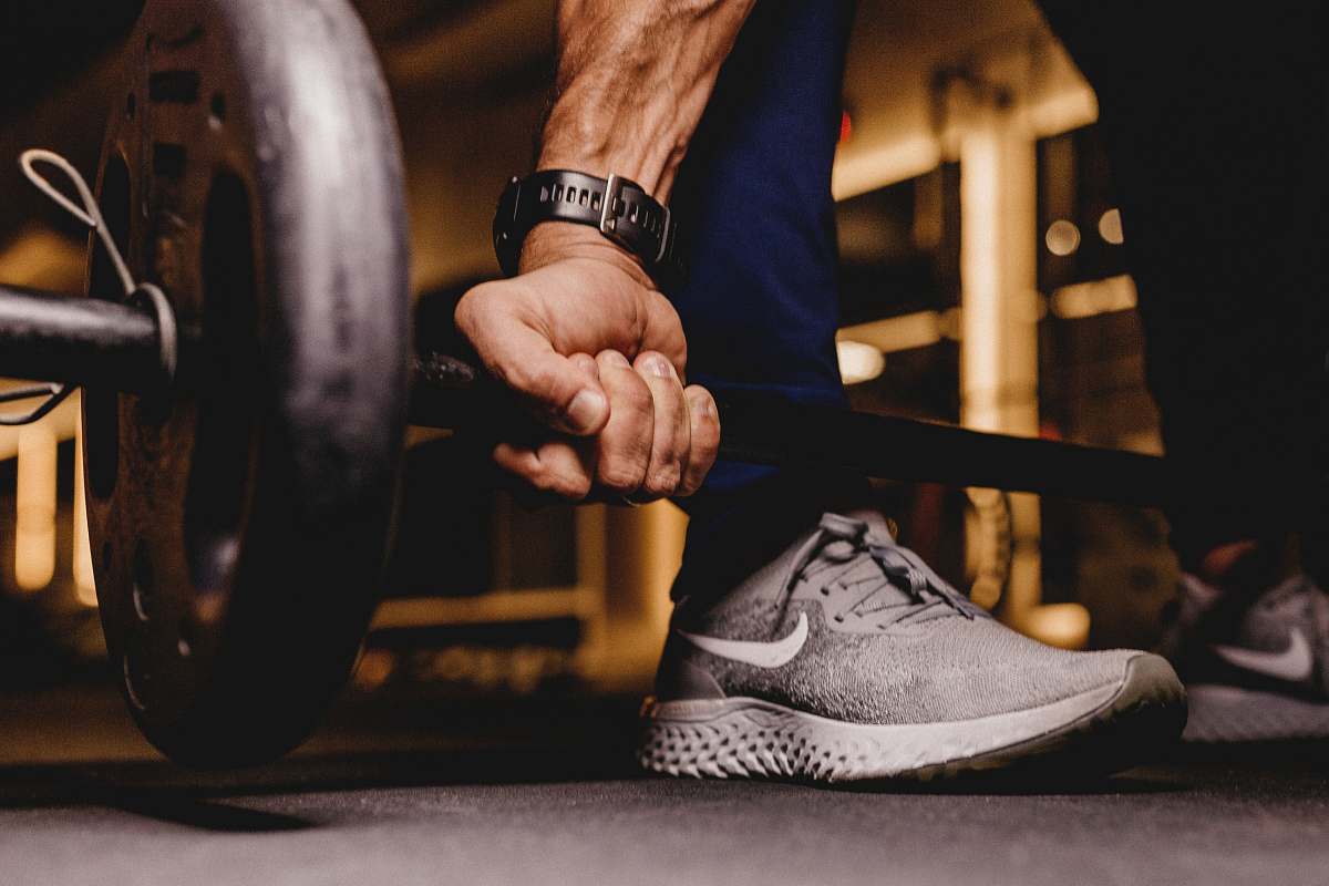 footwear person about to lift barbell clothing