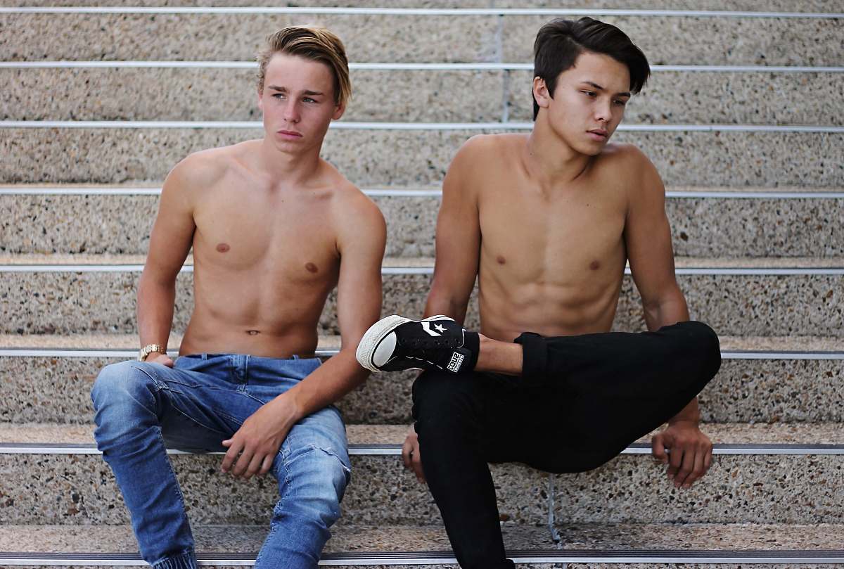 jeans two topless men wearing denim jeans sitting on stairs denim
