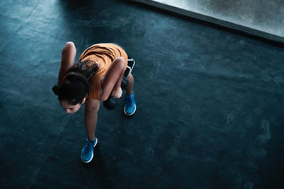 footwear woman in orange top exercising indoors shoe