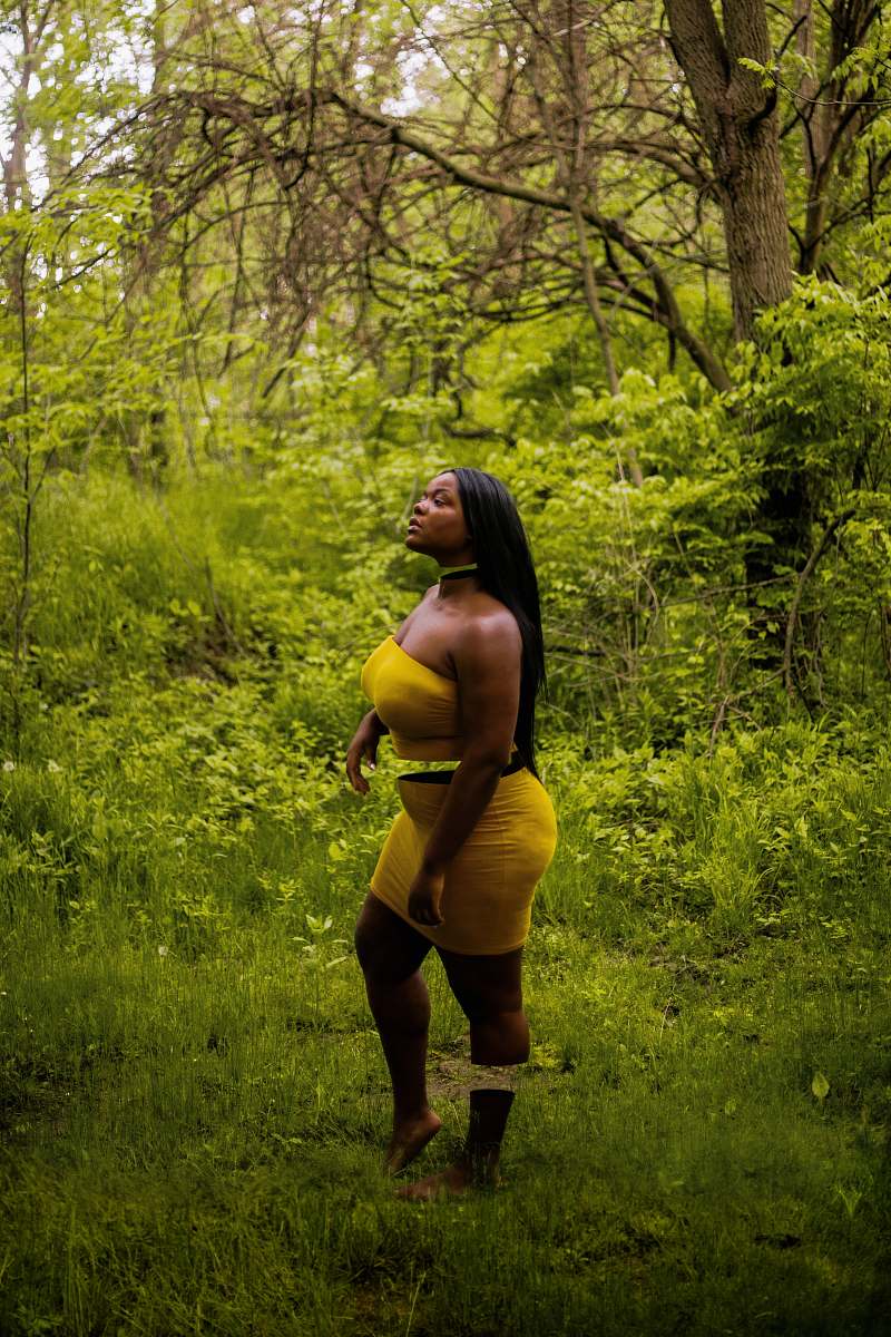 clothing woman wearing yellow strapless mini dress vegetation