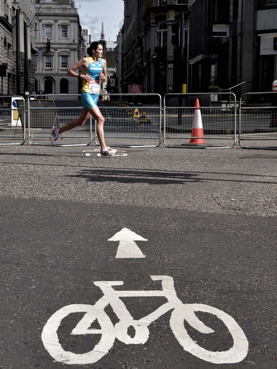 tarmac woman running on gray concrete pavement taken at daytime london