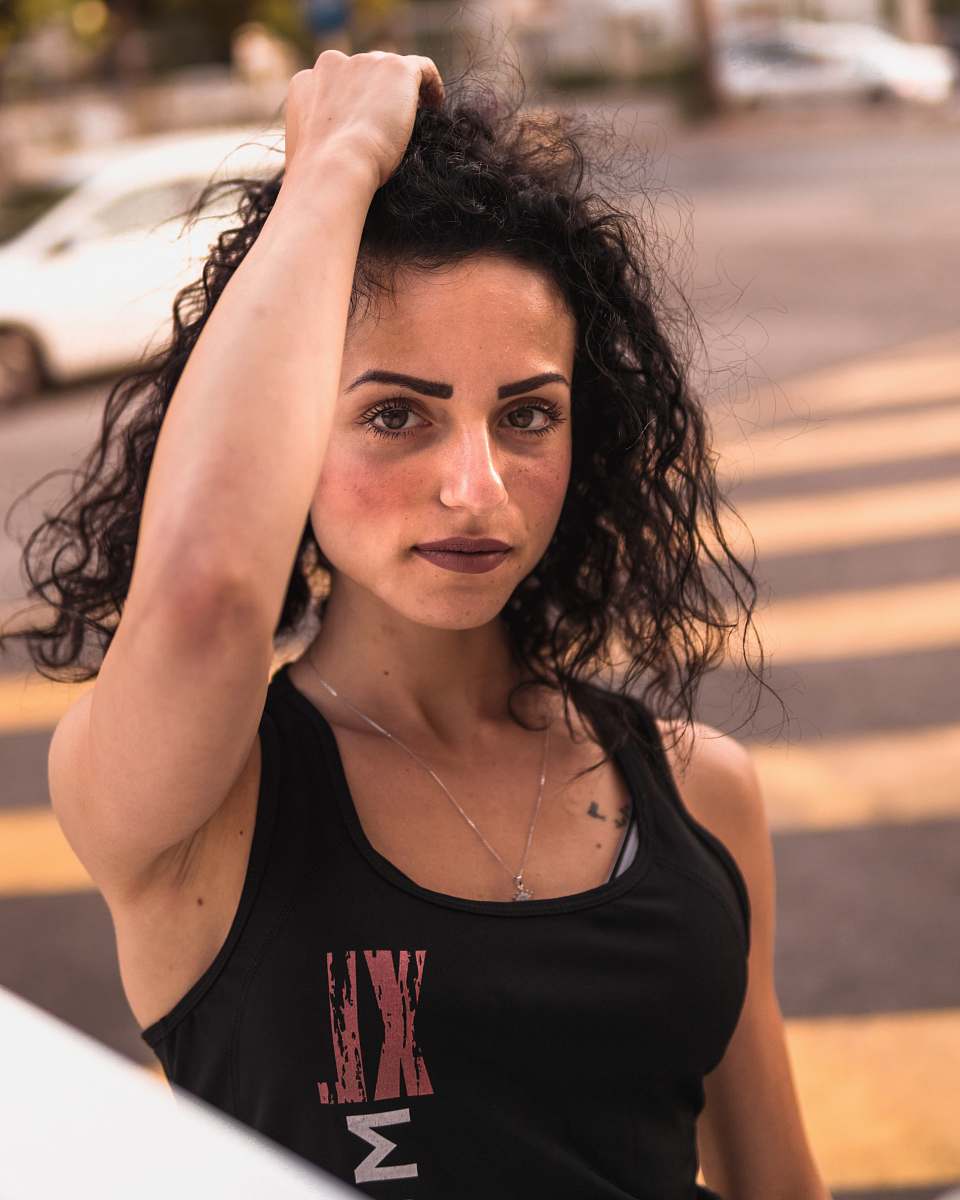 tarmac women wearing a black tank top close-up photography person