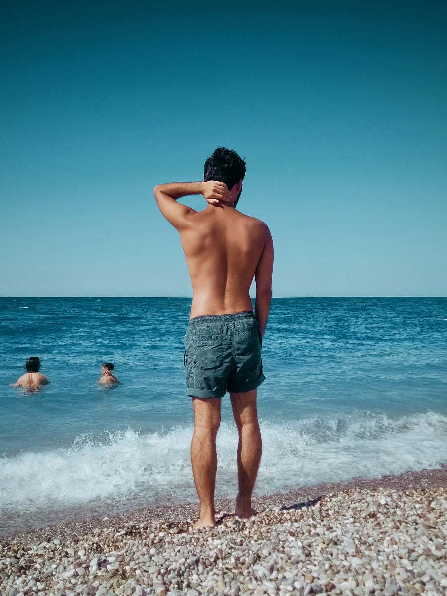 apparel man standing on shore clothing