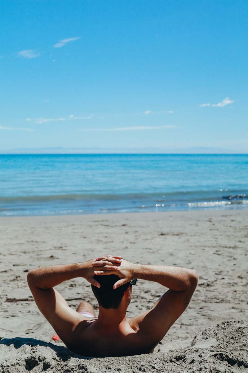 coast man leaning on beach ocean