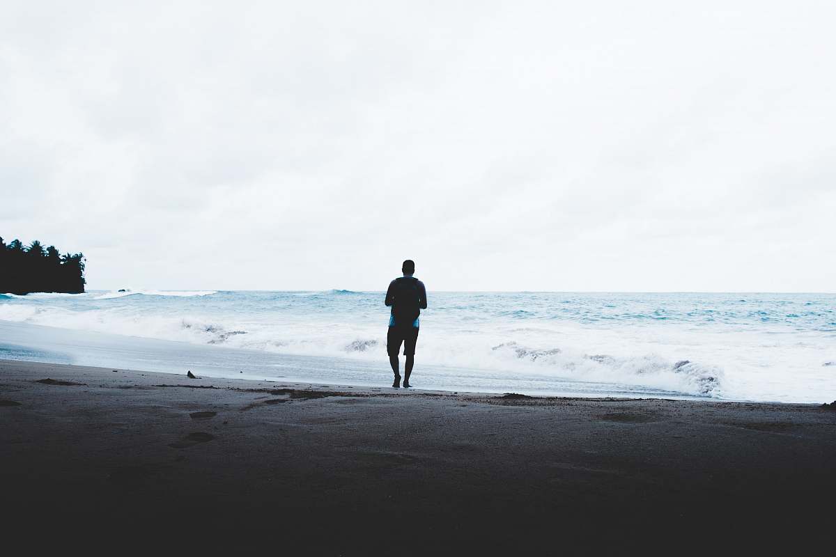 ocean man standing beside seashore sea