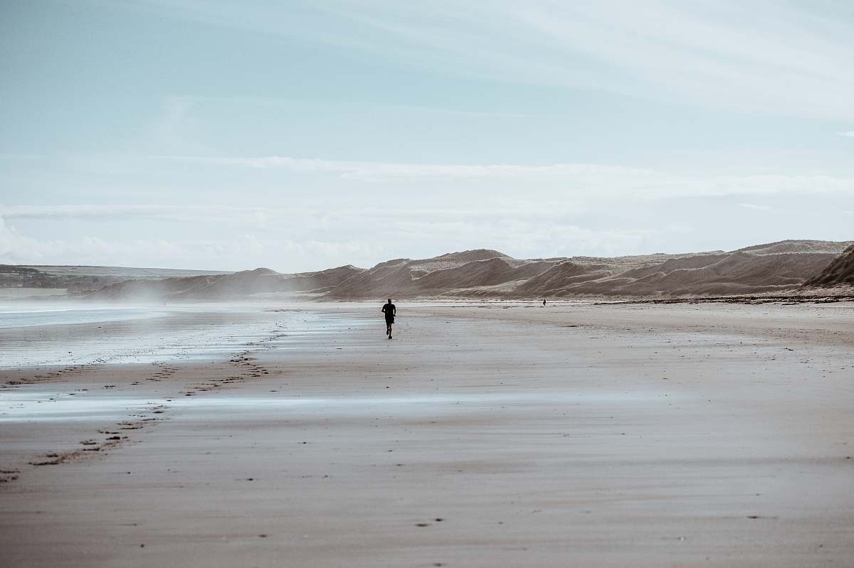 ocean person running on desert grey