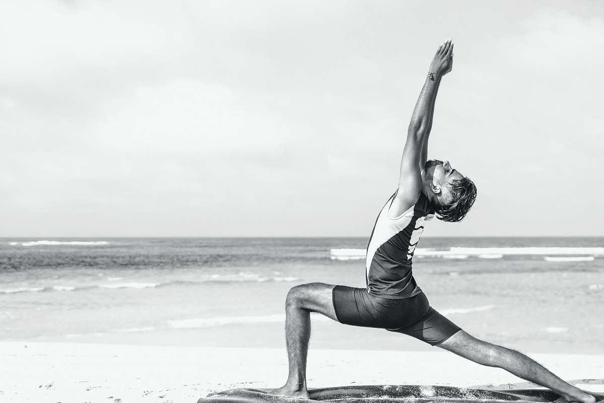 exercise man stretching on seashore yoga