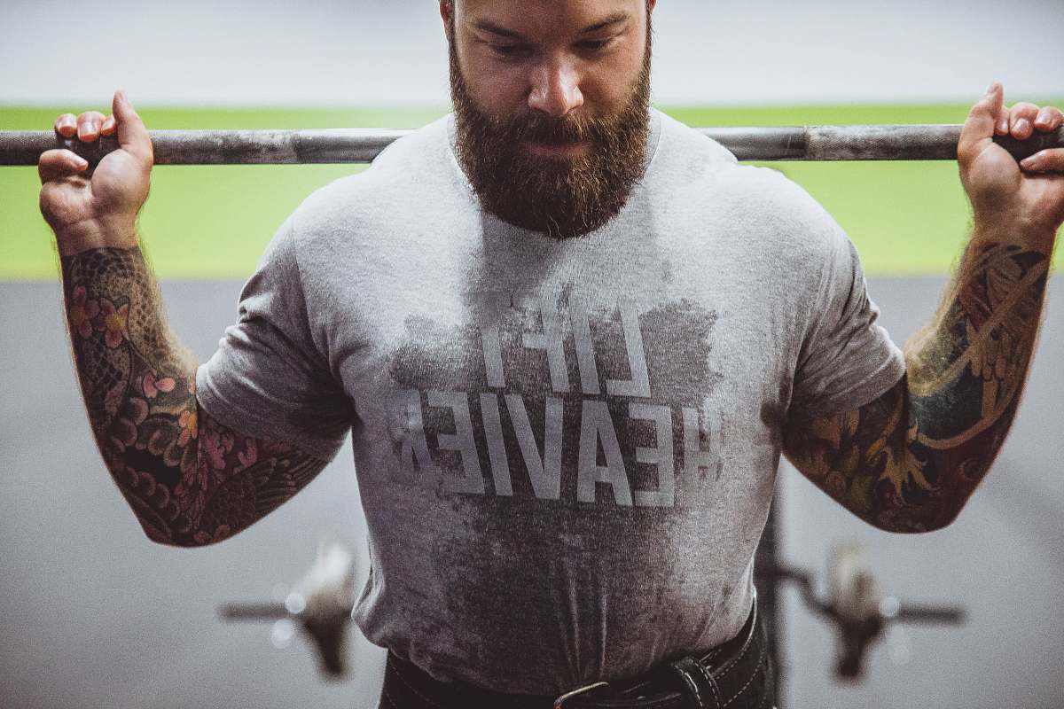 guelph man body-building holding steel bar arm