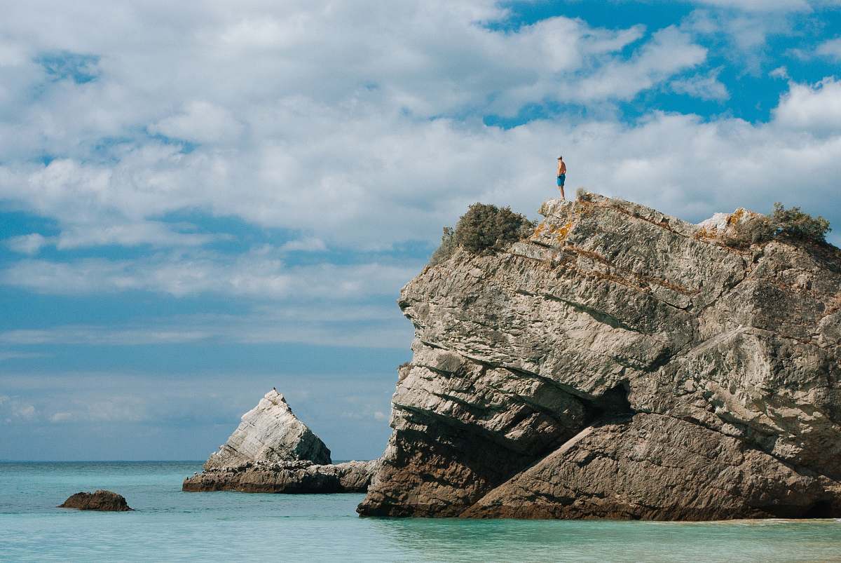 outdoors man standing on cliff mountain