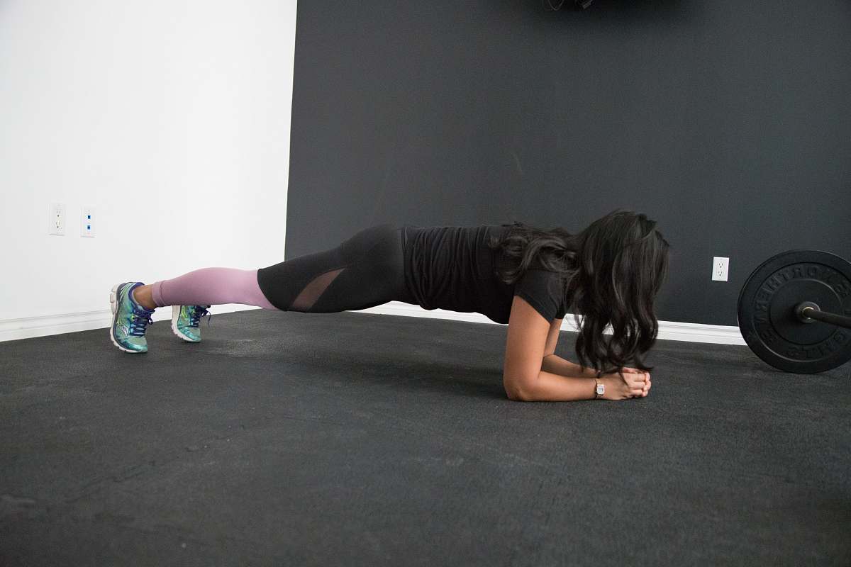 apparel person planking on floor shoe