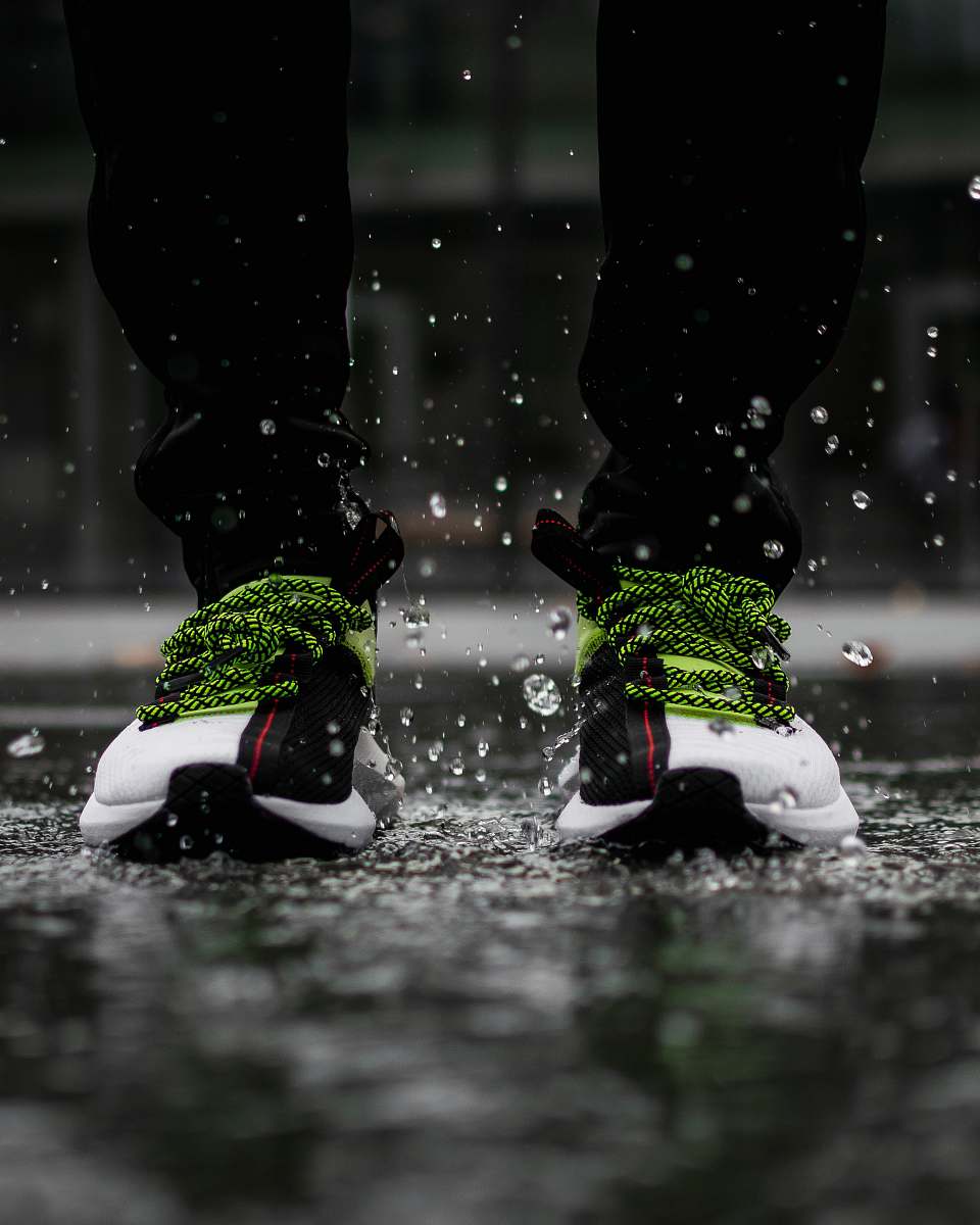 apparel person standing on watery ground shoe