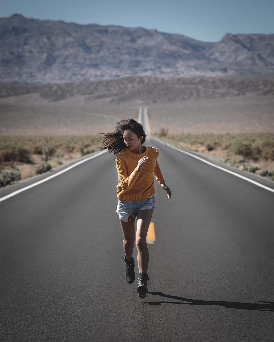 apparel woman running on road during daytime shorts