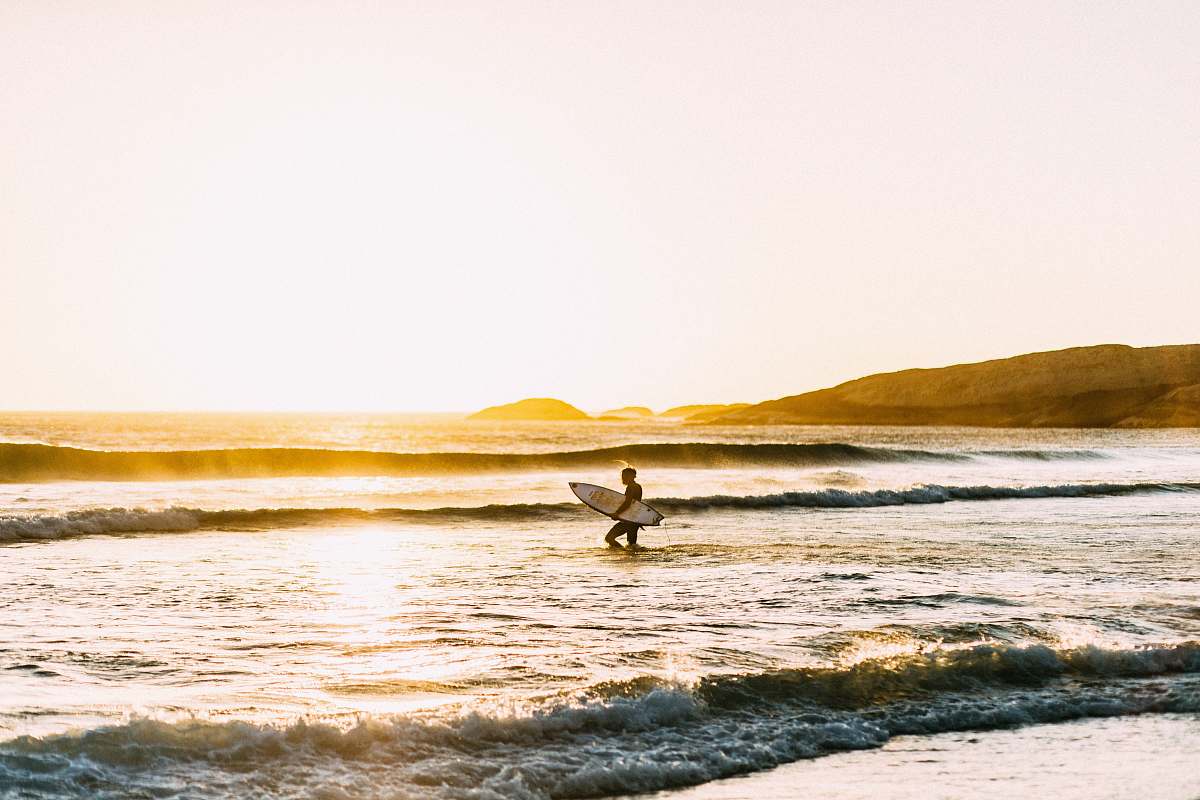 ocean man holding his surfboard sea
