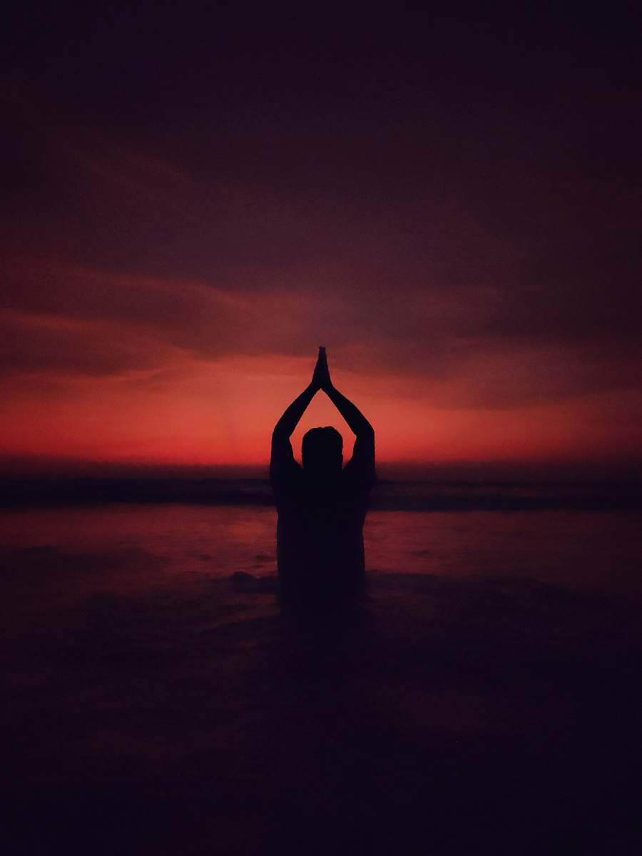sports person performing yoga position working out