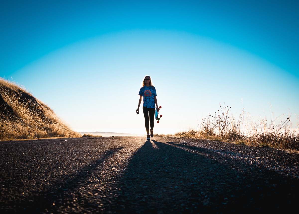 jogging person standing holding skateboard fitness