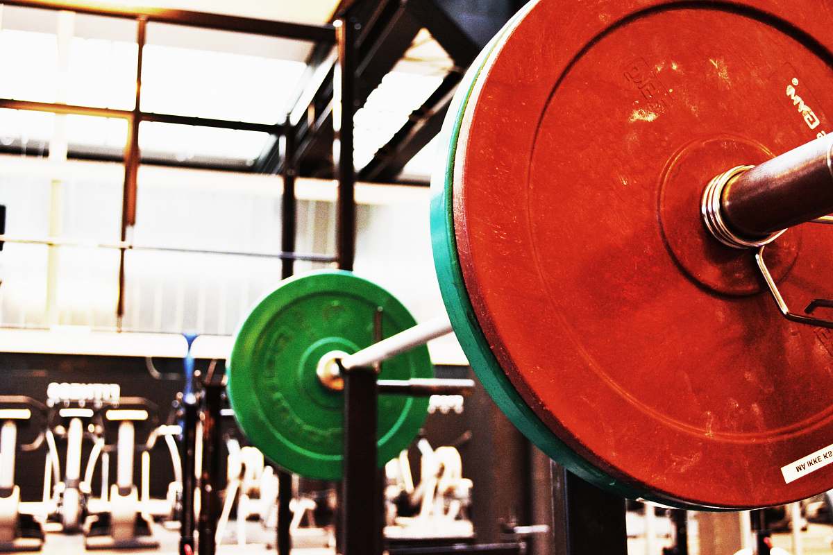red red and green barbell on rack word