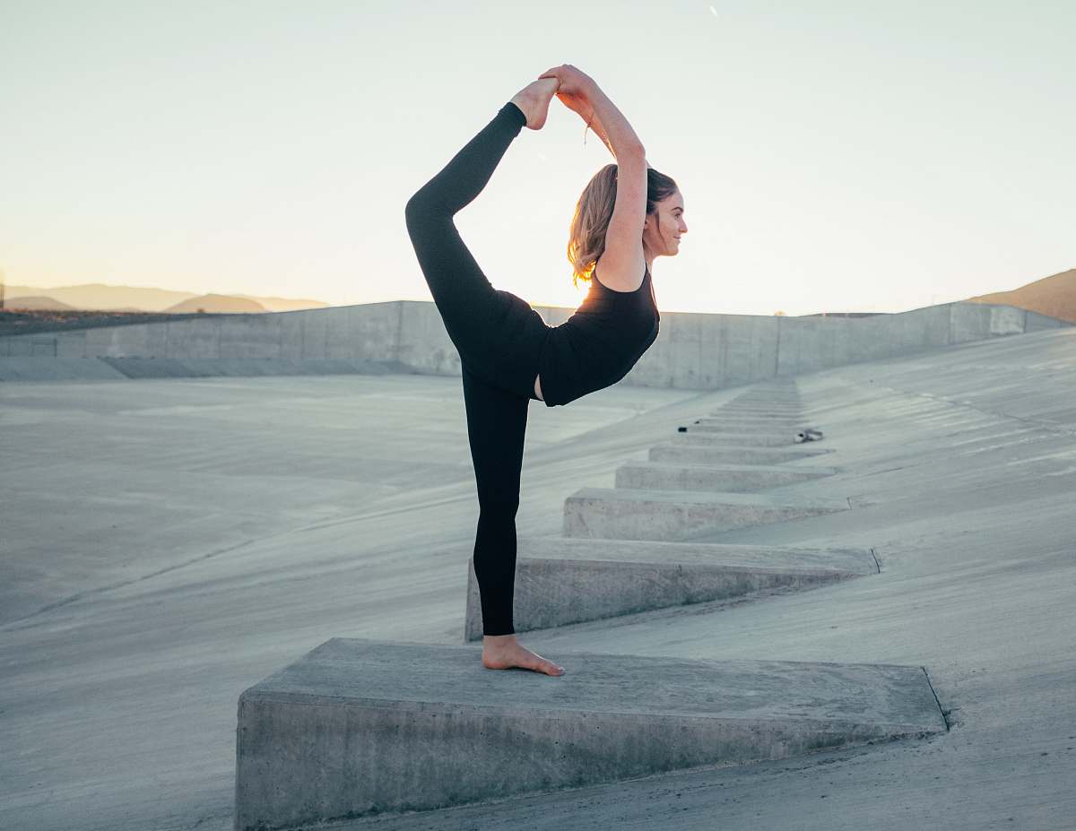 exercise shallow focus photo of woman in black sleeveless shirt doing yoga working out