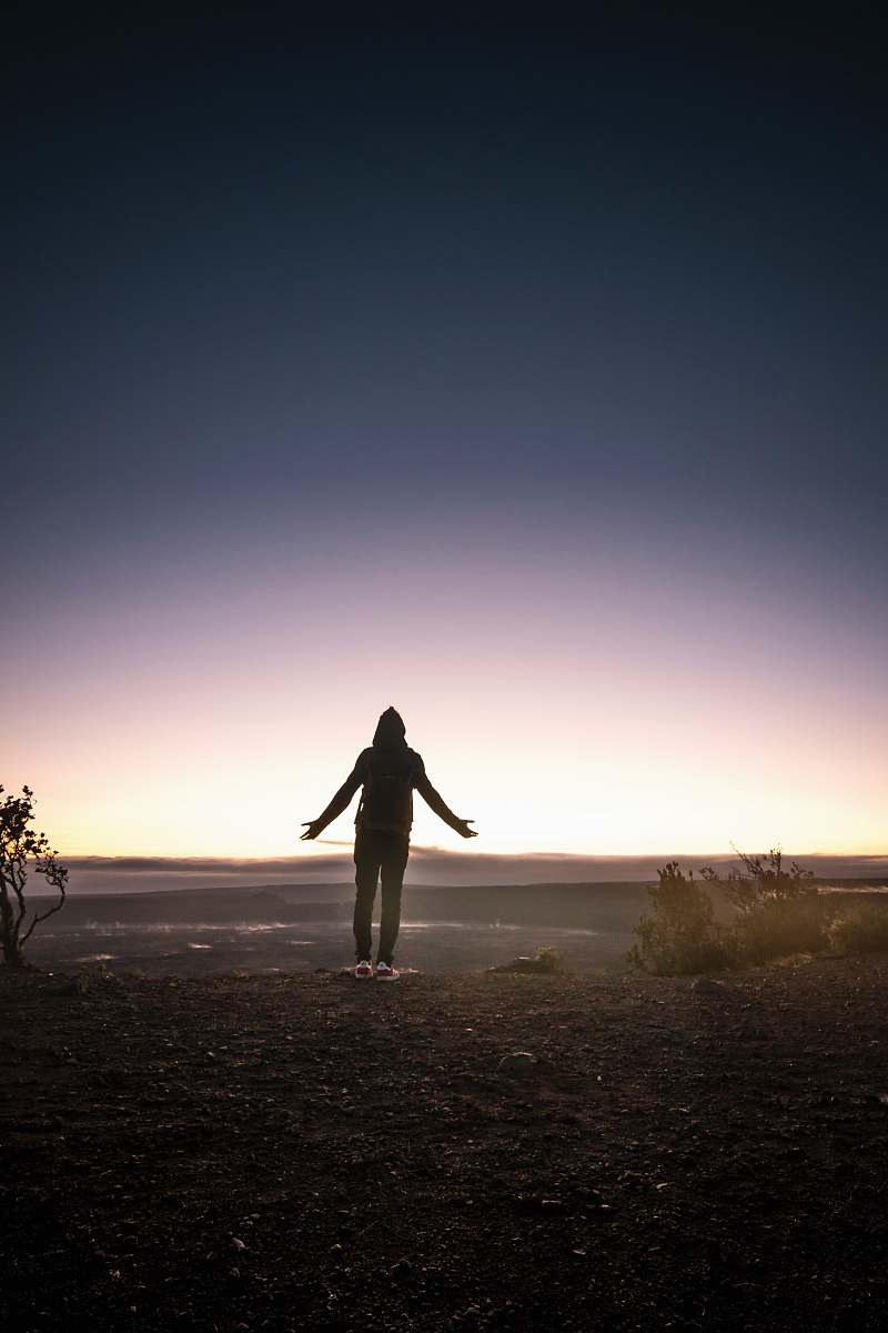 volcano silhouette of person standing on mountain top exercise