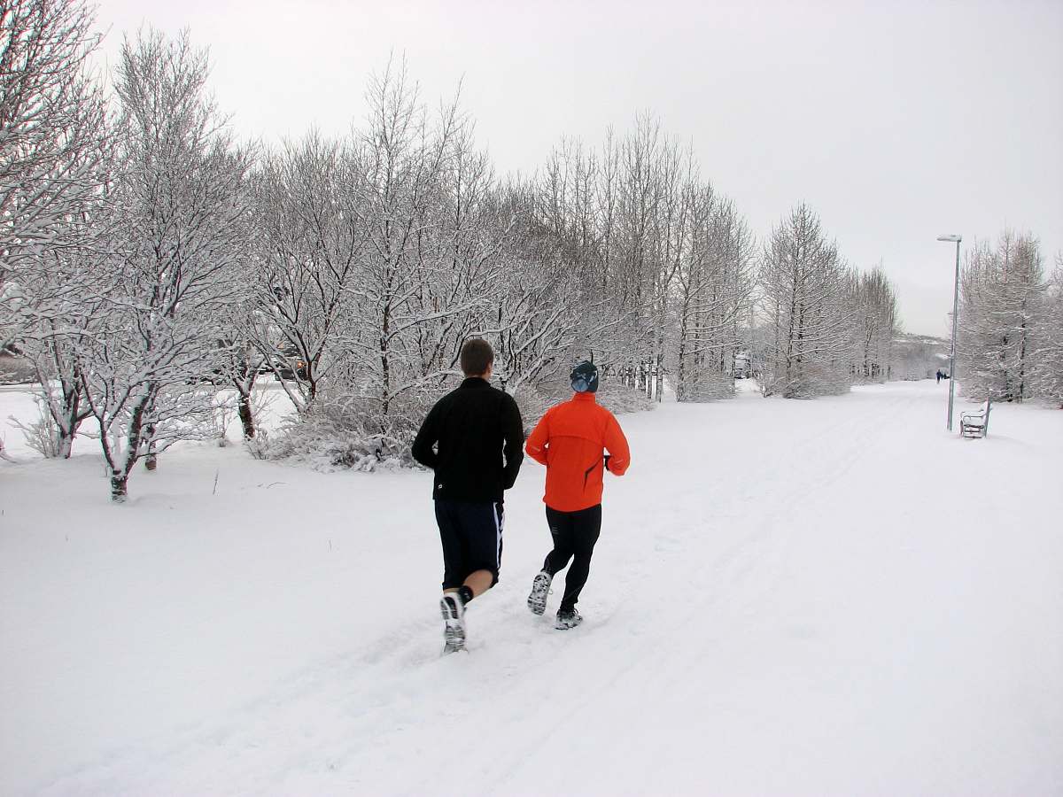 person two persons running on snow field near trees human