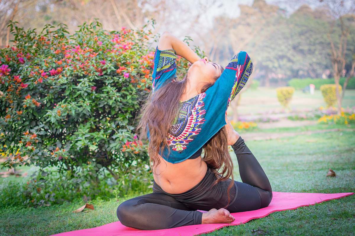 human woman wearing black pants and blue floral croptop girl
