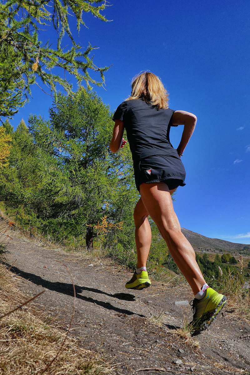 human woman wearing blue T-shirt surrounded by trees sports