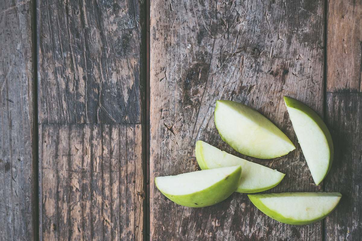 food five green apple slices on brown wooden panel apple