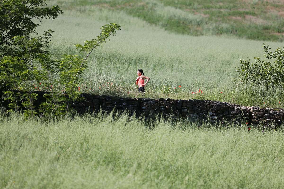 outdoors woman running through grass field