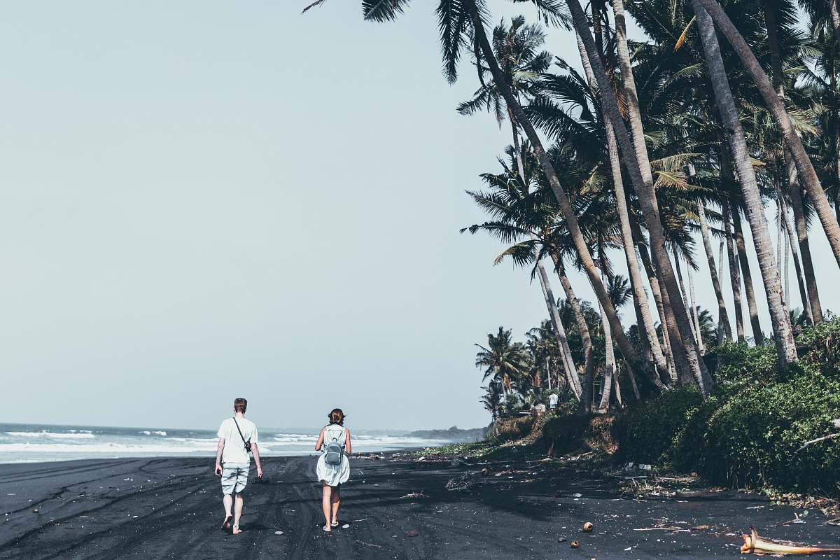 nature man and woman standing on the seashore coast