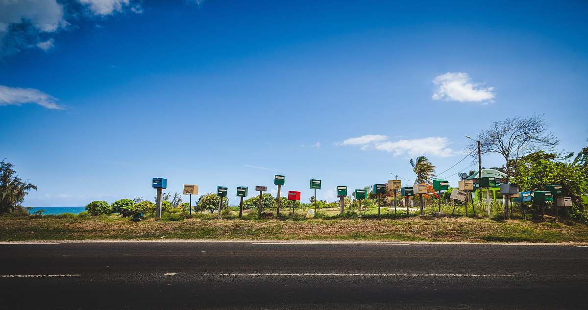 blue post signage near street road