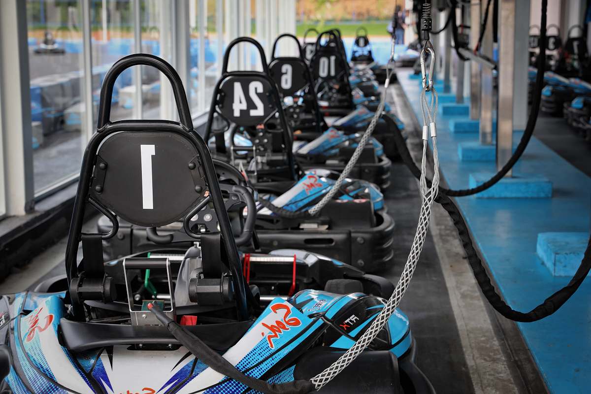 person blue and black kart on track side exercise
