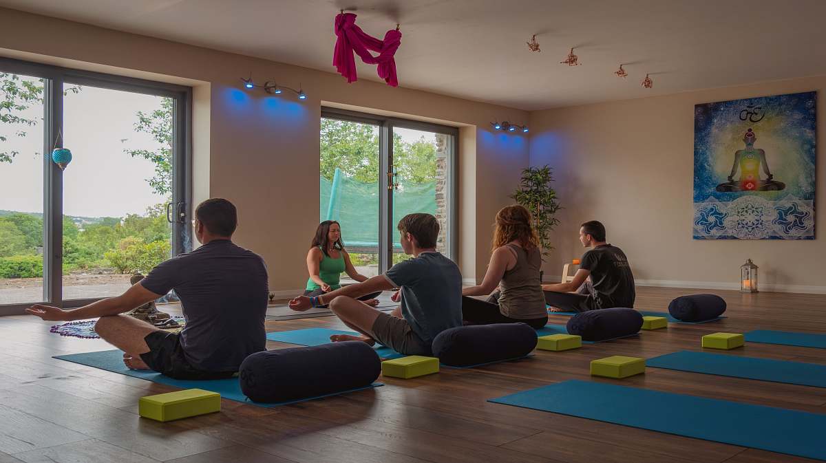 person five persons doing yoga inside room exercise