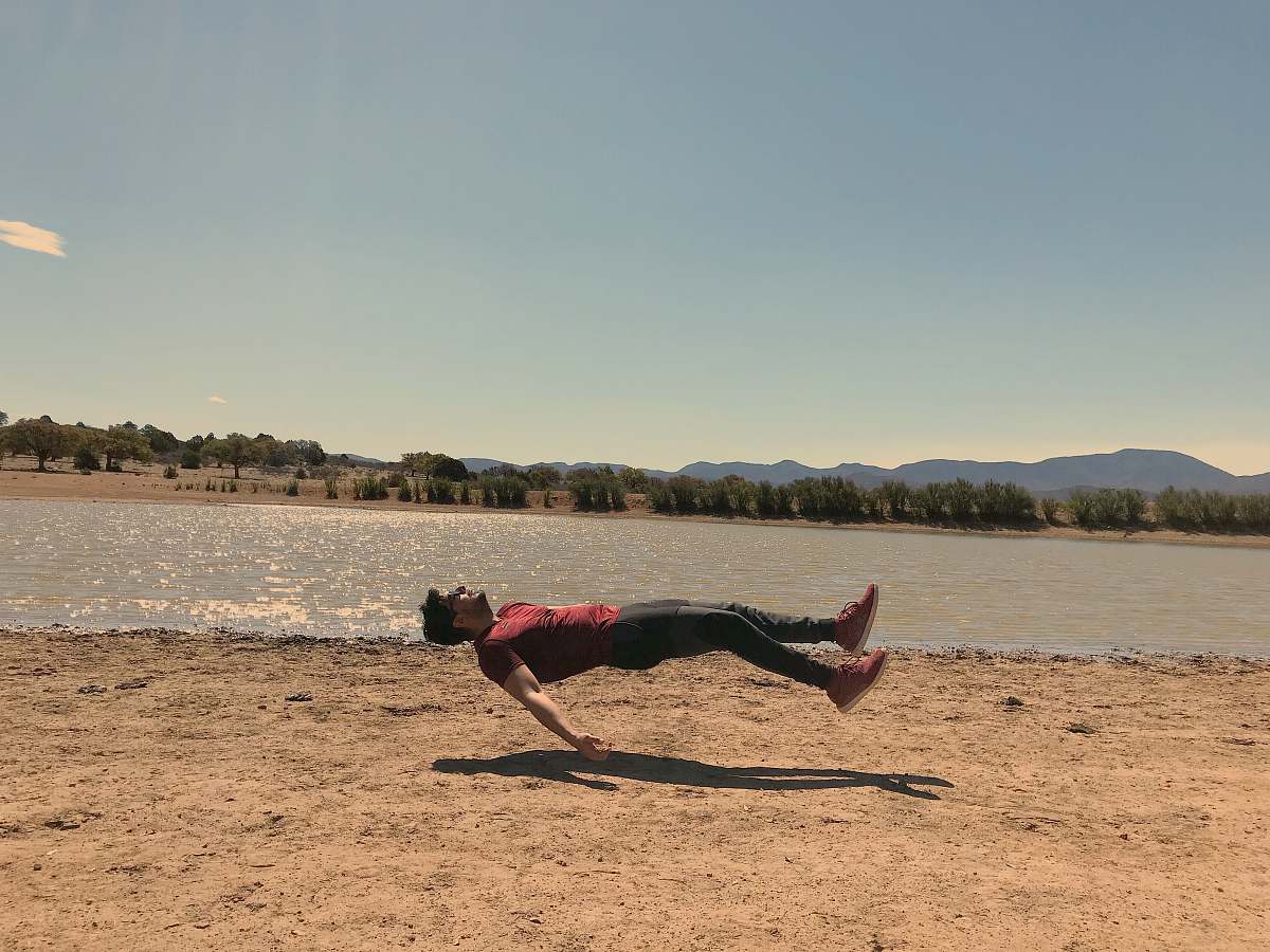 person floating man wearing red t-shirt during daytime apparel