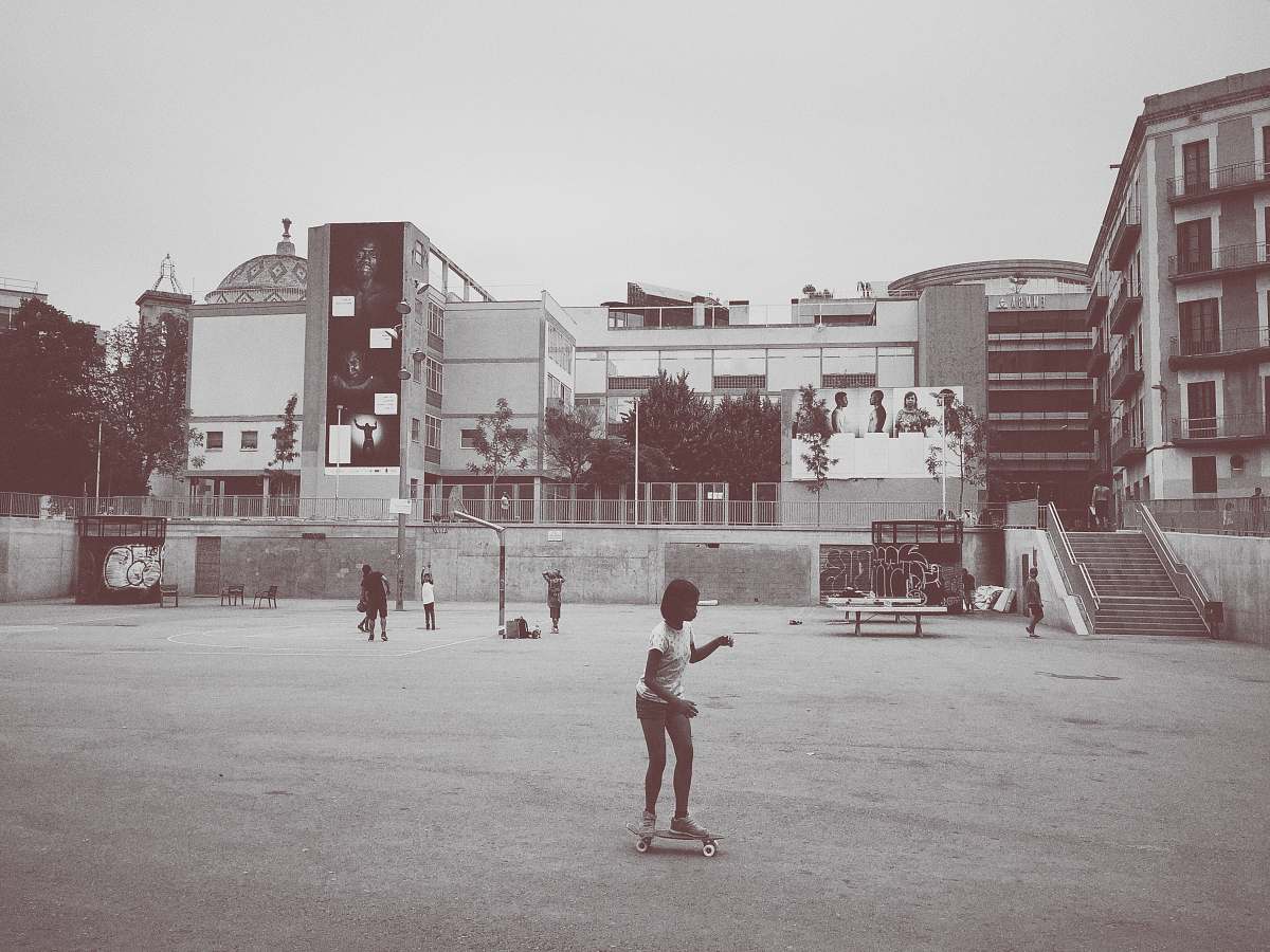 people girl ride on skateboard near building grey