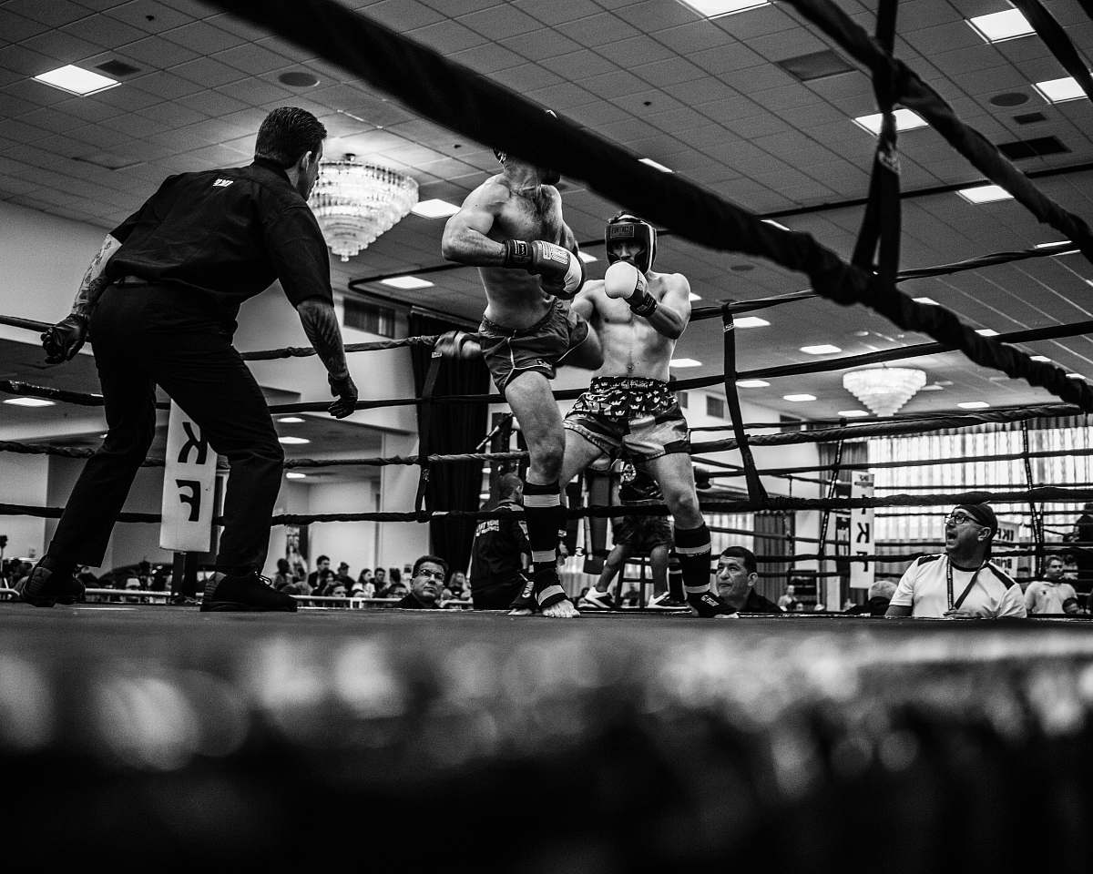 person grayscale photo of mix martial arts fight black-and-white