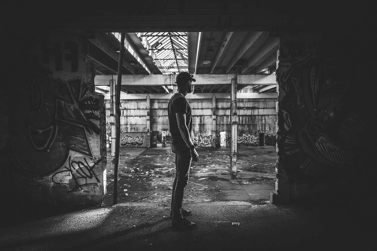 person grayscale photography of man in building black-and-white