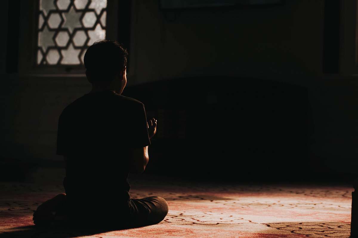 person low-light photo of man sitting on the floor kuala lumpur