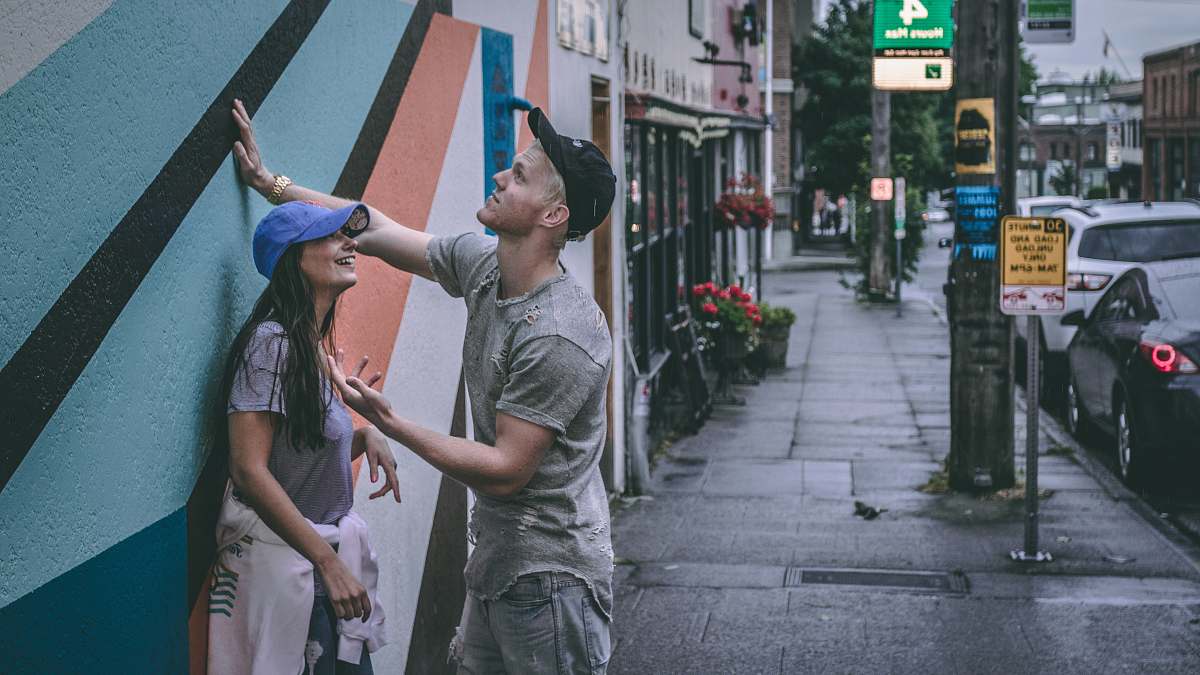 person man and woman near wall clothing