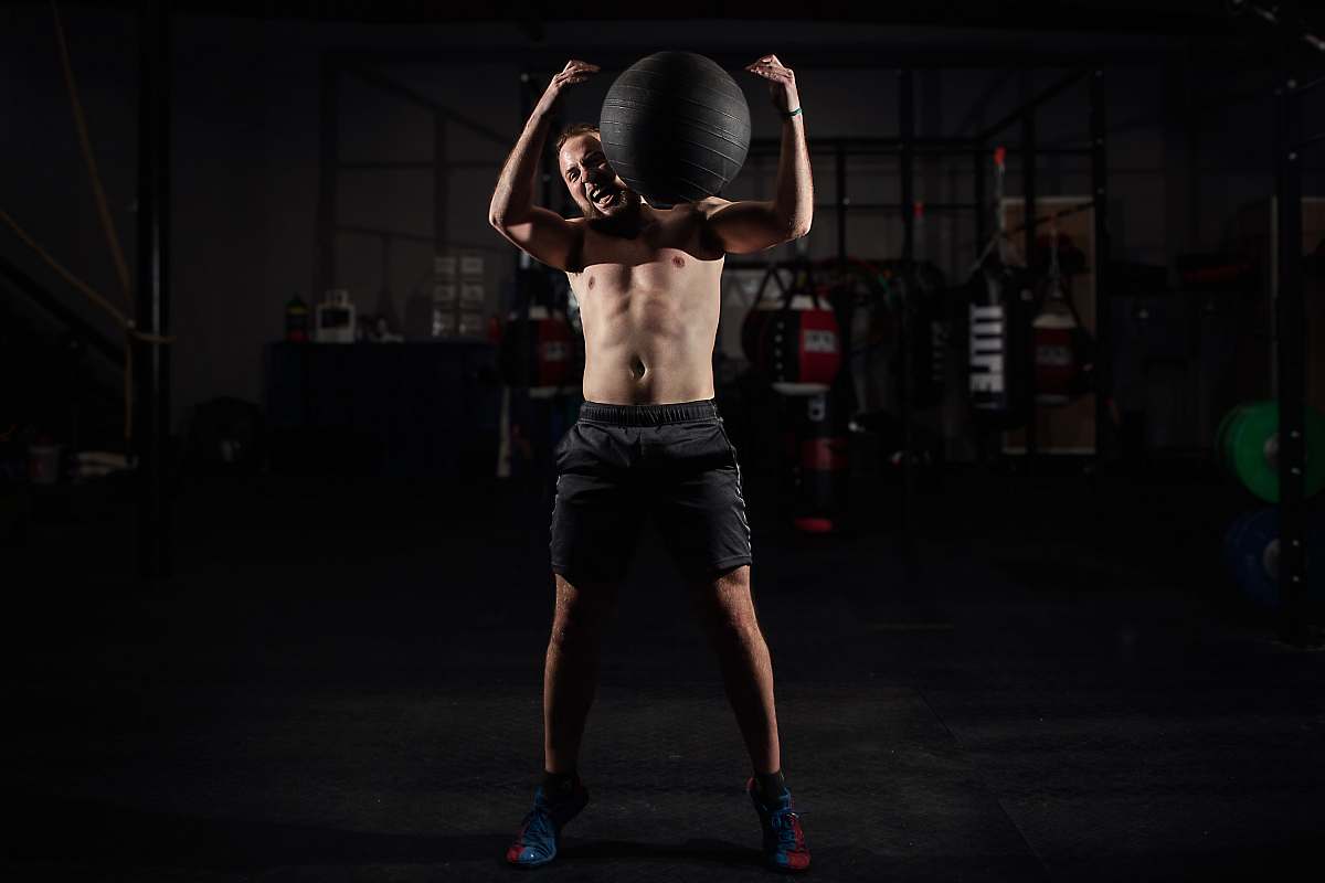 person man carrying stability ball people