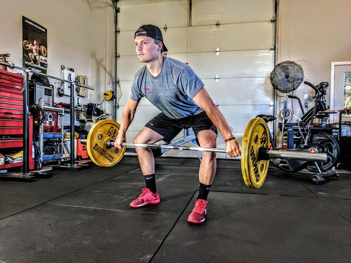 exercise man carrying yellow barbell people