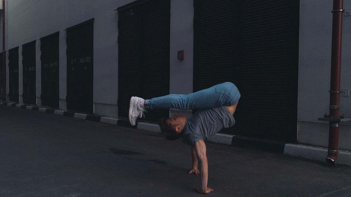 person man doing handstand man